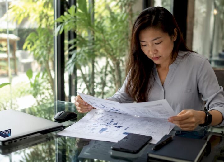 Essentials of network reliability for IT managers - Re-solution IT manager reviewing network reliability documents