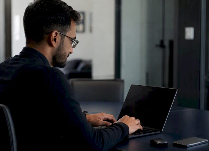 Microsoft Partner Network programme: a guide for UK technology businesses - Re-solution Hands managing laptop for cloud partnership