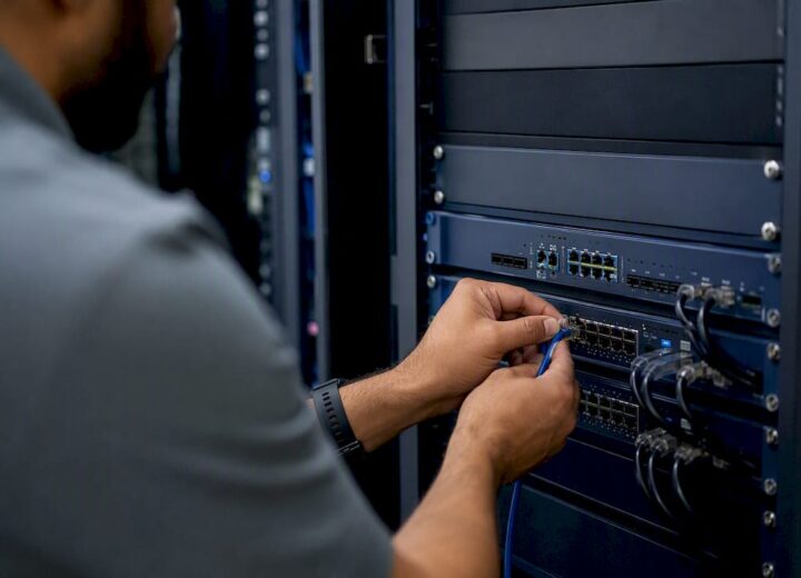 SD-WAN failover design: a playbook for network architects - Re-solution Hands connecting cable to SD-WAN device