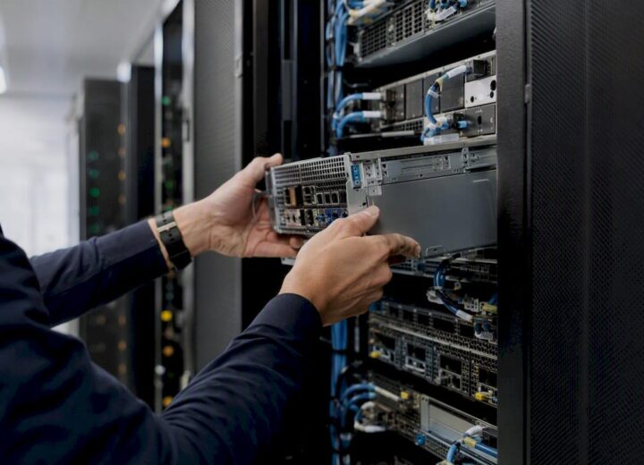 Hands installing modular hardware in server rack