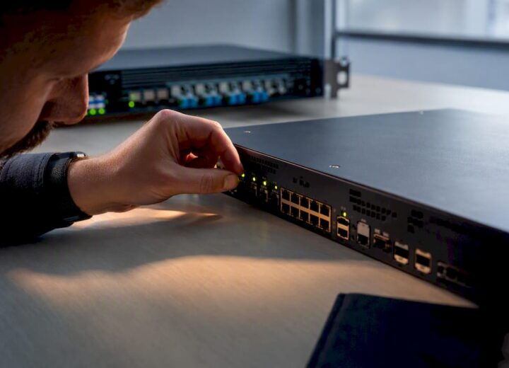 Engineer inspecting anonymous SD-WAN edge hardware